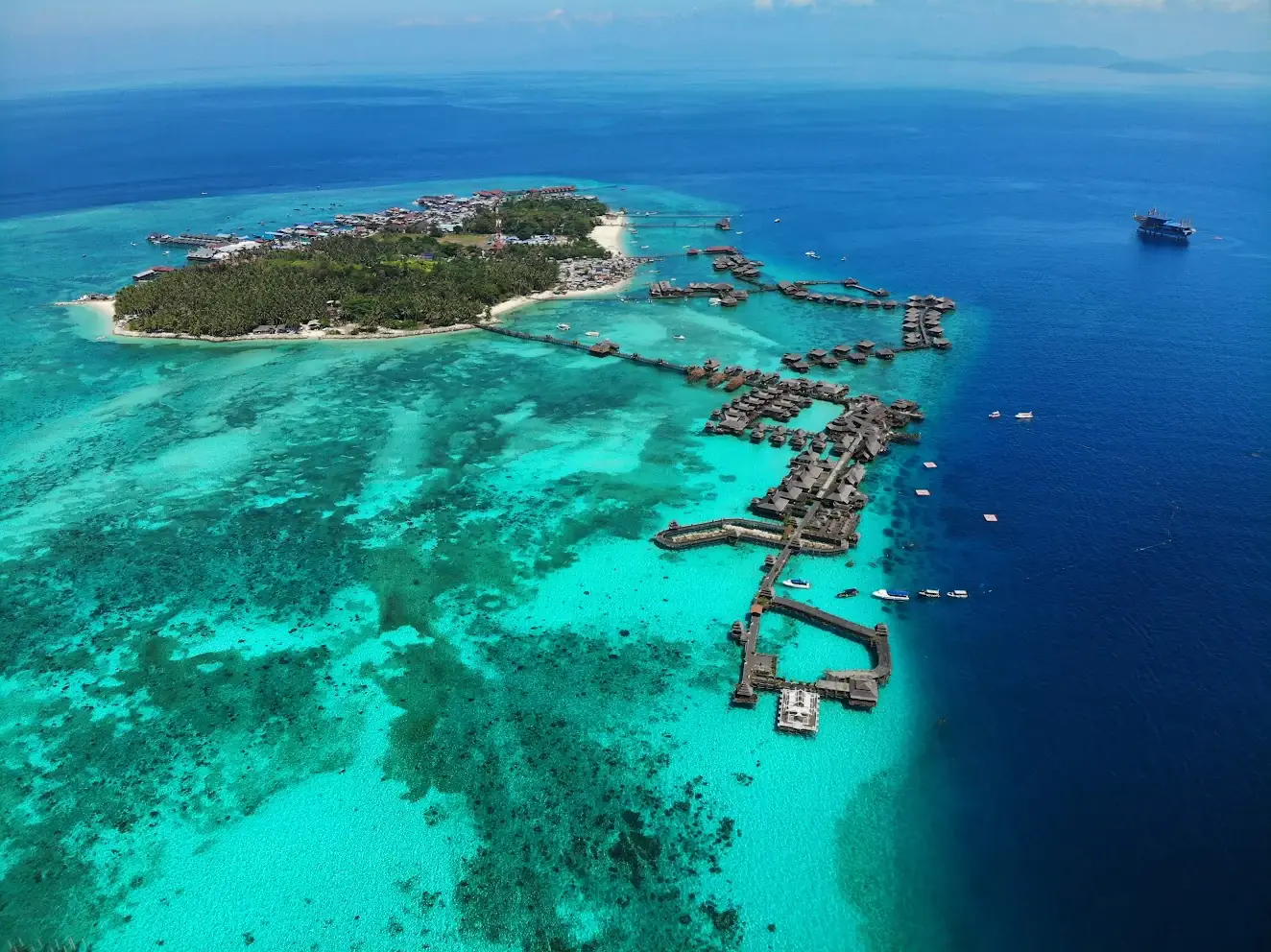 Aerial view of Mabul island and its turquoise shallows opening into the deep blue sea