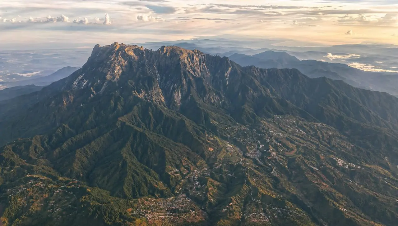 Aerial view of Mount Kinabalu and its forested ridges at sunrise